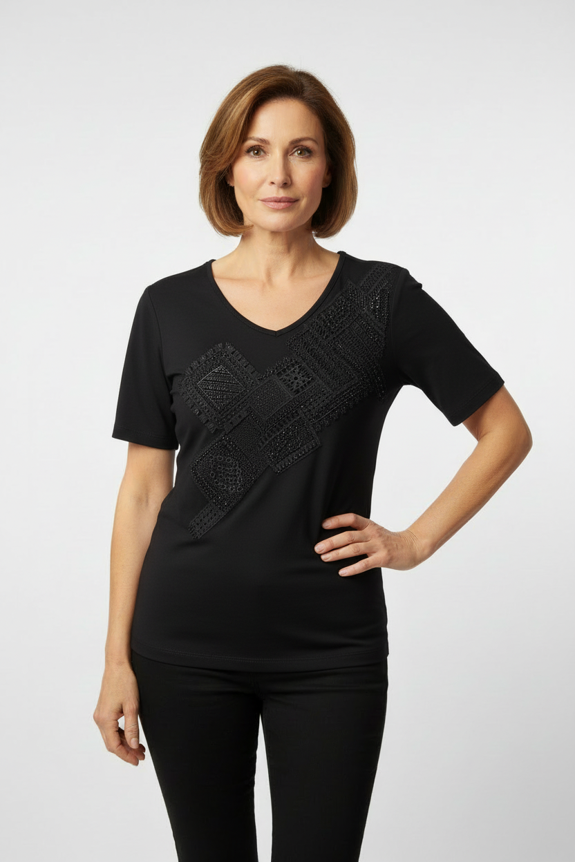 Mature model wearing black embellished top with elbow-length sleeves