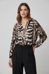 Abstract print blouse with black trousers
