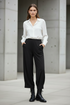 Black Noen trousers styled with feminine military boots