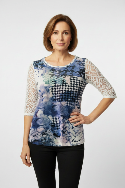 Mature model wearing artistic blue print top with lace sleeves