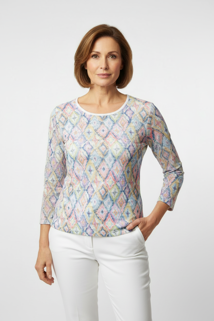 Mature model wearing Libra mesh top with white trousers