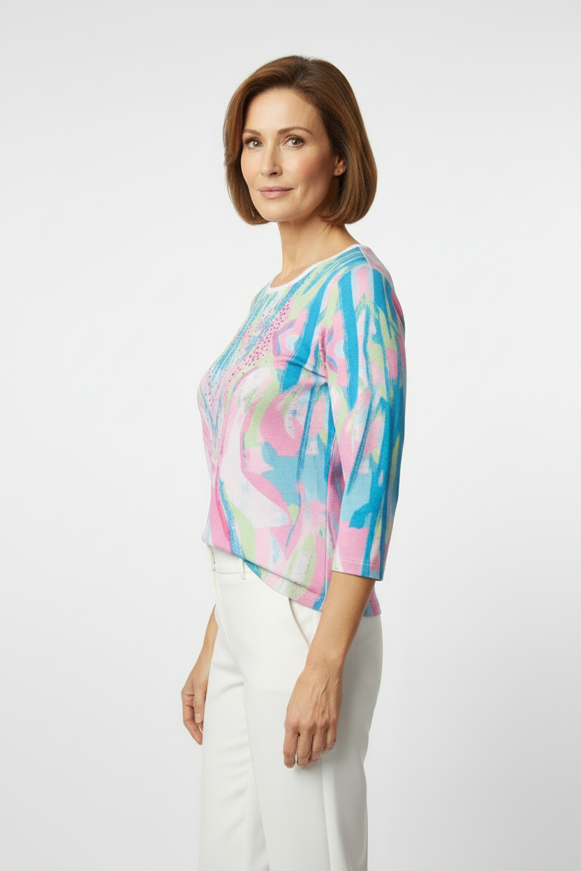 Mature model wearing vibrant abstract print top - side view