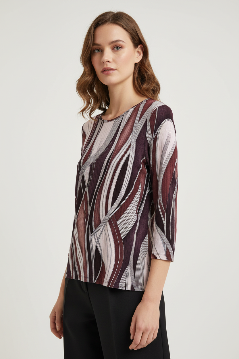 Model wearing burgundy geometric print top