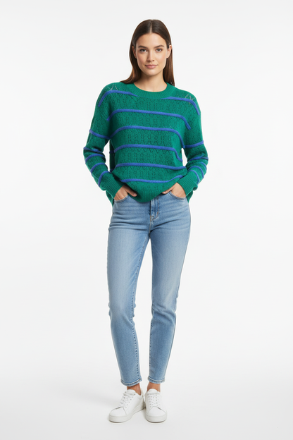 Model wearing green knit with blue stripes