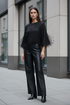 Noen model wearing the fringed sheer-sleeve top