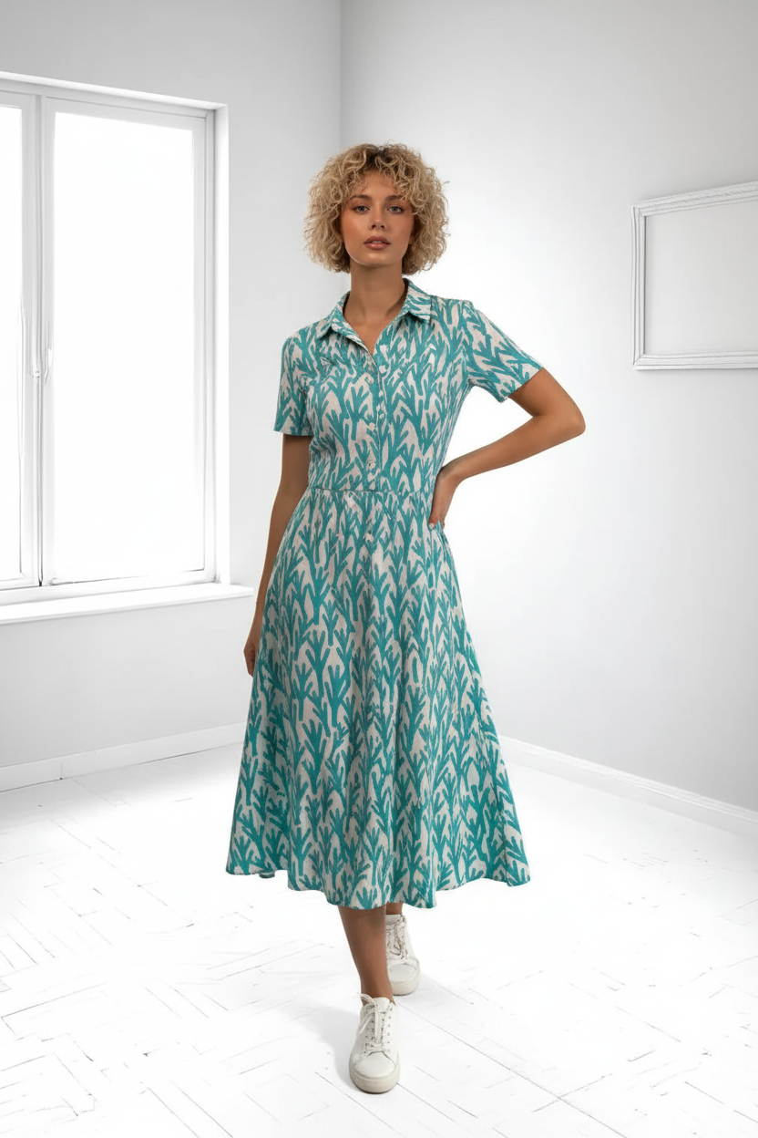 Turquoise leaf print dress with streamlined skirt