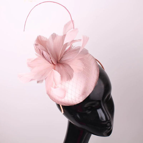 Pillbox style fascinator with feather and spike detail on band D04