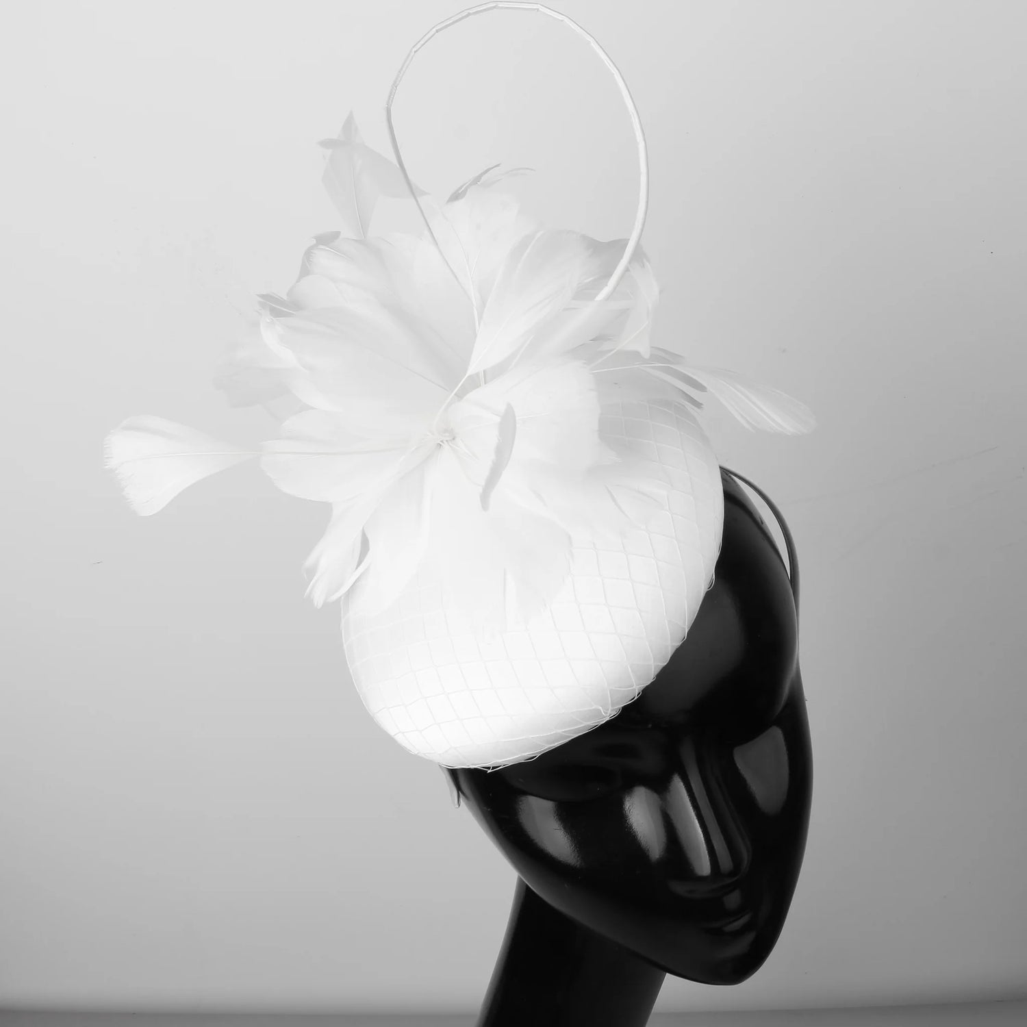 Pillbox style fascinator with feather and spike detail on band D04