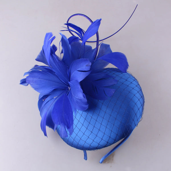 Pillbox style fascinator with feather and spike detail on band D04